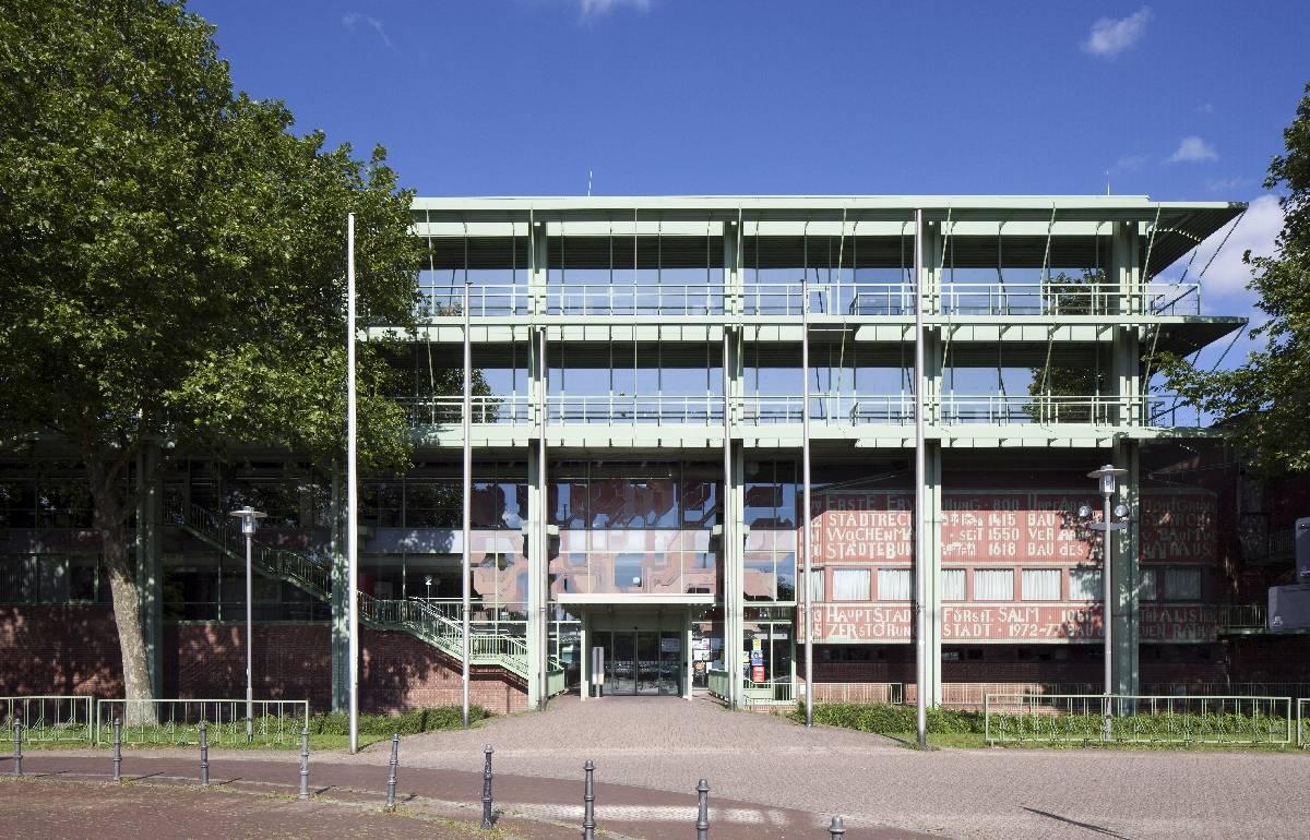 frontaler Blick auf die Fassade mit grünen Stahlelementen